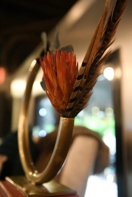Seasonal details, like this flower and feather, can be changed out to compliment foundational design elements, like this metal decorative item, that stay in the home throughout the year at Dish and Design Cozy Comfort event at  Great Lakes Culinary Center in Southfield, Mich. on Sept. 20, 2022.