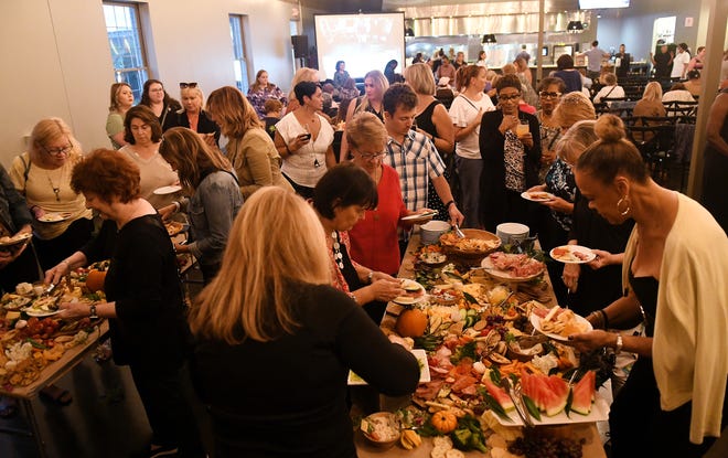 Attendees partake in the appetizers provided by Busch's Fresh Food Market at Dish and Design Cozy Comfort event at  Great Lakes Culinary Center in Southfield, Mich. on Sept. 20, 2022.
