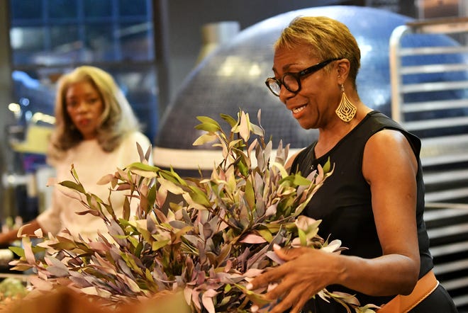 Savvy Chic owner Karen Brown shows how to decorate for fall with silk flowers at Dish and Design Cozy Comfort event at  Great Lakes Culinary Center in Southfield, Mich. on Sept. 20, 2022.