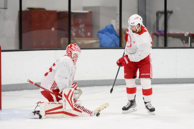 Center Dylan Larkin tries to deflect the puck past goaltender Ville Husso during the Red Wings’ training camp at Centre Ice Arena.
