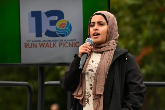 Maria Saad sings the national anthem during the 13th annual Run Walk Picnic at Ford Field Park, Saturday, Sept. 24, 2022, in Dearborn, Mich. (Jose Juarez/Special to Detroit News)