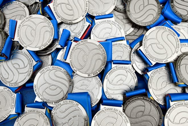 Pariticipant medals were handed out to all runners taking part in the Zaman International 13th annual Run/Walk at Ford Field Park, Saturday, Sept. 24, 2022, in Dearborn, Mich.