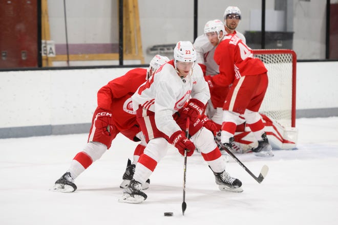 Left wing Lucas Raymond tries to keep control of the puck during the Red Wings’ training camp at Centre Ice Arena.