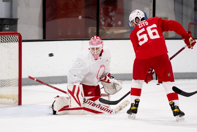 Center Pasquale Zito tries to deflect the puck past goaltender Ville Husso during the Red Wings’ training camp at Centre Ice Arena.