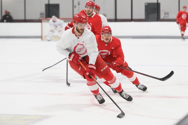 Center Michael Rasmussen, front, keeps the puck away from defenseman Donovan Sebrango during the Red Wings’ training camp at Centre Ice Arena.