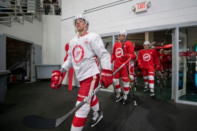 Left wing Lucas Raymond, left, and the rest of the team heads out onto the ice during the Red Wings’ training camp at Centre Ice Arena in Traverse City on Saturday, Sept. 24, 2022.