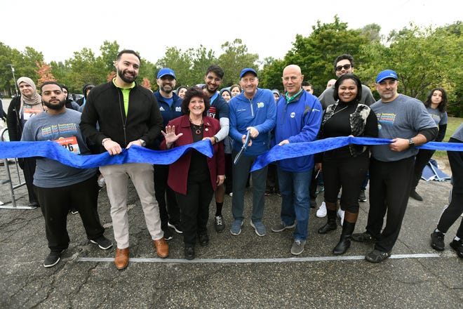 Local elected officials and digniaries help with the ribbon cutting ceremony to officially kick off the Zaman International 13th annual Run Walk Picnic at Ford Field Park, Saturday, Sept. 24, 2022, in Dearborn, Mich. (Jose Juarez/Special to Detroit News)