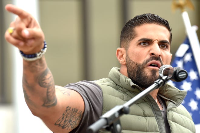 Concerned parent Hassan Chami, of Dearborn, speaks passionately from the podium, Sunday afternoon, September 25, 2022.