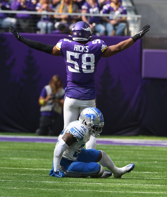 Lions' D'Andre Swift sits for a moment after getting hit by Vikings' Jordan Hicks, causing a dropped pass, in the third quarter.