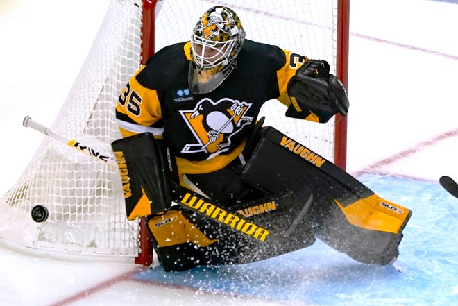 Penguins goaltender Tristan Jarry sweeps the puck away after a shot by the Red Wings during the first period.