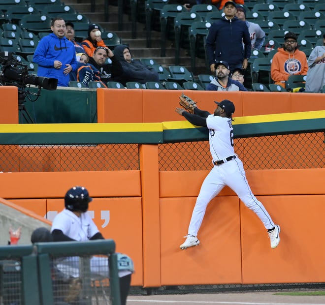 Tigers left fielder Akil Baddoo jumps but can't get to a home run ball off the bat of Royals' Hunter Dozier in the second inning.