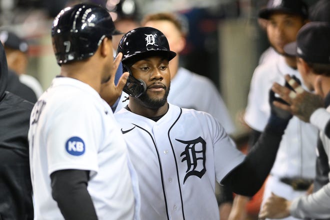 From left, Tigers' Jonathan Schoop congratulates Akil Baddoo after they score on a single by Harold Castro in the eighth inning to tie the game at 3-all.