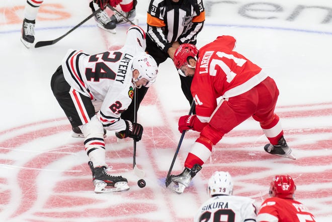 Chicago center Sam Lafferty, left, and Detroit center Dylan Larkin battle for a face off during the third period.