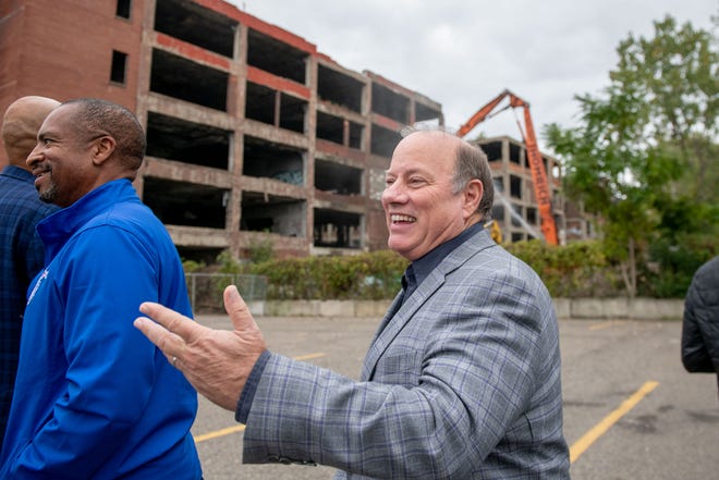 Detroit Mayor Mike Duggan smiles as demolition equipment begins work on tearing down one building of the former Packard plant, in Detroit, September 29, 2022.