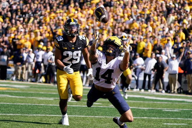 Michigan wide receiver Roman Wilson (14) makes a diving attempt to catch a pass ahead of Iowa defensive back Sebastian Castro (29) during the first half.