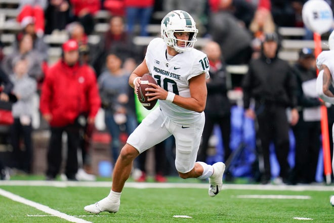 Michigan State quarterback Payton Thorne rolls out against Maryland during the first half.