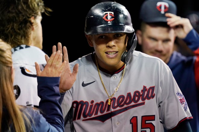 Minnesota Twins' Gio Urshela is greeted in the dugout after scoring during the fourth inning.