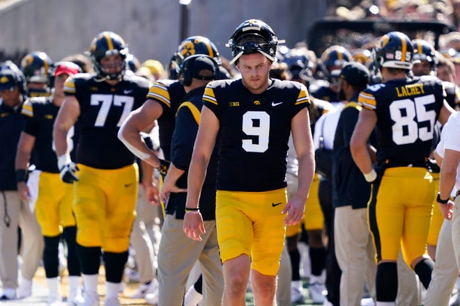 Iowa punter Tory Taylor (9) walks on the sideline during the second half.