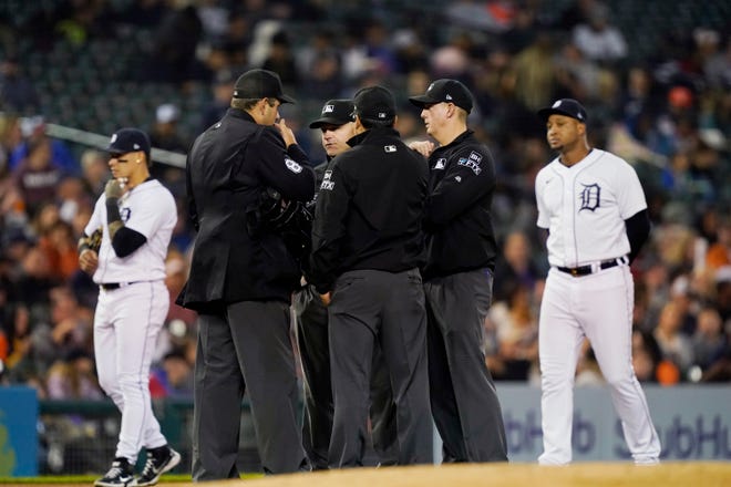 Umpires meet to discuss possible fan interference on a double by Minnesota Twins' Ryan Jeffers during the fourth inning.