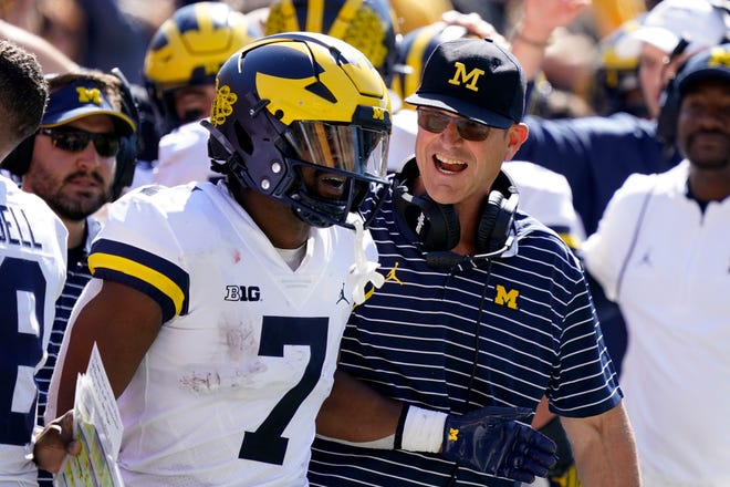 Michigan running back Donovan Edwards (7) celebrates with head coach Jim Harbaugh after catching a 12-yard touchdown pass during the second half.