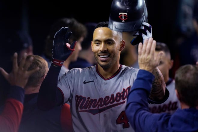 Minnesota Twins' Carlos Correa is greeted in the dugout after his two-run home run during the seventh inning.