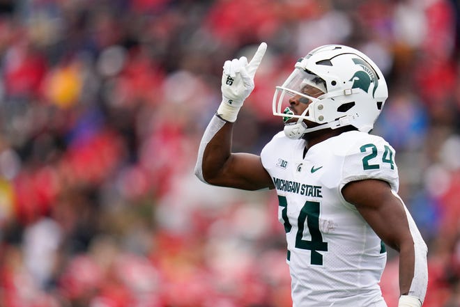 Michigan State running back Elijah Collins gestures after scoring a touchdown against Maryland during the first half.