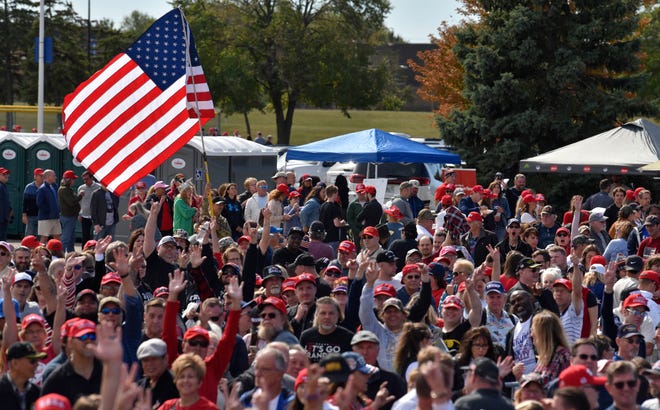 Throngs of people wait to enter the rally for former president Donald Trump at Macomb Community College Sports & Expo Center in Warren, Saturday, October 1, 2022. Trump is campaigning for Republican candidates Tudor Dixon, Matt DePerno and Kristina Karamo, candidates for governor, attorney general and secretary of state, respectively.