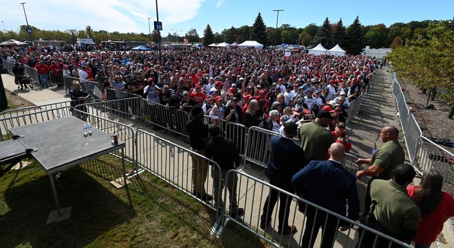 Throngs of people wait to enter the rally for former president Donald Trump.