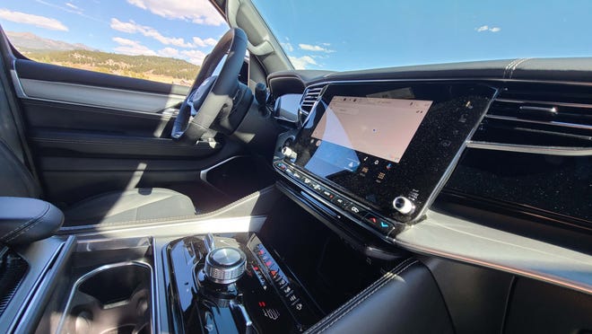 The console of the 2023 Jeep Wagoneer L has lots of space for cups, phones - and drive modes.