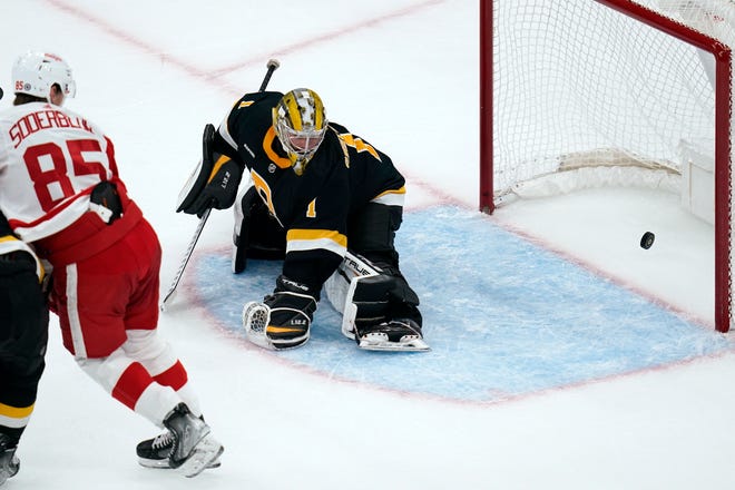 Boston Bruins goaltender Jeremy Swayman drops to the ice on a goal by Detroit Red Wings left wing Adam Erne during the second period of an NHL hockey game, Thursday, Oct. 27, 2022, in Boston. At left is Detroit Red Wings left wing Elmer Soderblom.