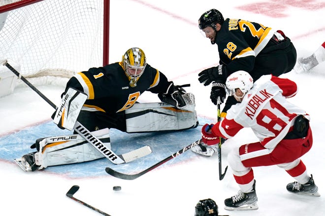 Boston Bruins goaltender Jeremy Swayman (1) makes a save on a shot by Detroit Red Wings left wing Dominik Kubalik (81) during the first period of an NHL hockey game, Thursday, Oct. 27, 2022, in Boston. At center is Boston Bruins defenseman Derek Forbort. (AP Photo/Charles Krupa)
