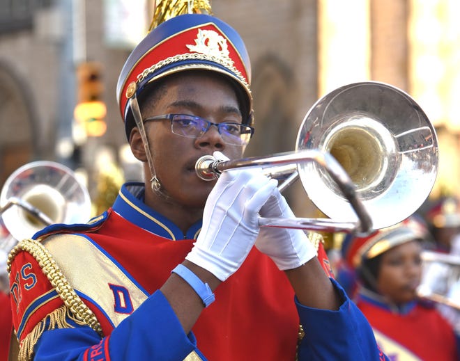 A trombone player from the Detroit Public Schools All City High School Marching Band plays during the parade.