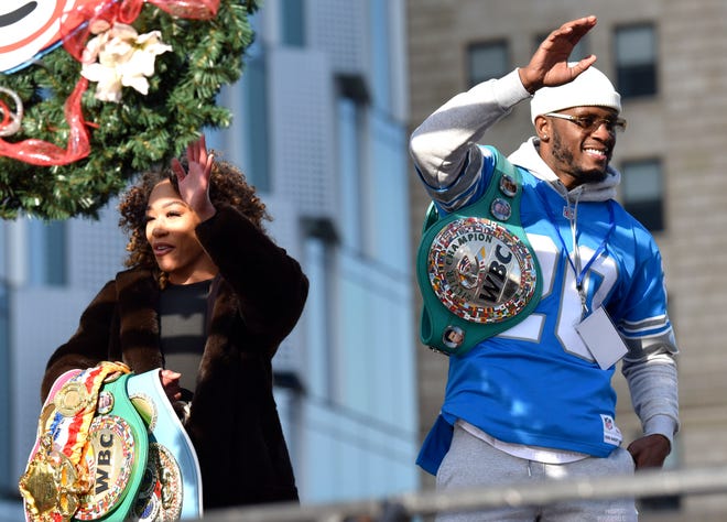 Boxing Champions Alycia Baumgardner and Tony Harrison wave during the parade.