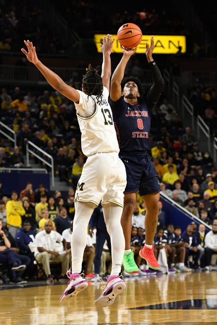 Jackson State guard Gabe Watson, right, shoots over Michigan guard Jett Howard in the first half of an NCAA college basketball game, Wednesday, Nov. 23, 2022, in Ann Arbor, Mich. (AP Photo/Jose Juarez)