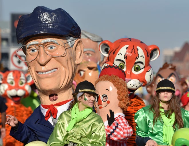 Ernie Harwell, left, and other members of the Big Head Corps during the parade.