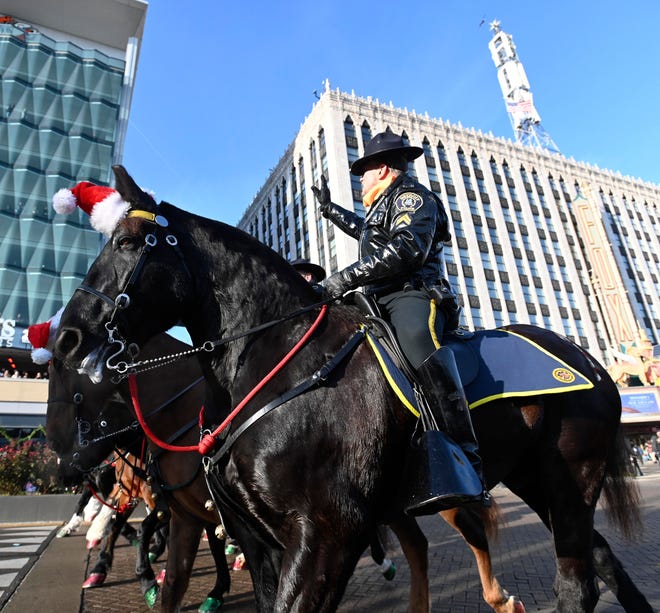 Members of the Detroit Police Mounted Unit wave during the parade.