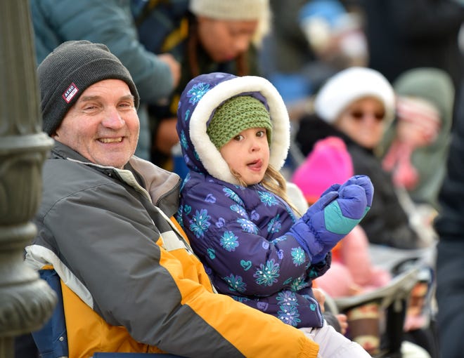 John Cline and family friend Moorea Stahl, 5, both of Mount Clemens, watch the parade.
