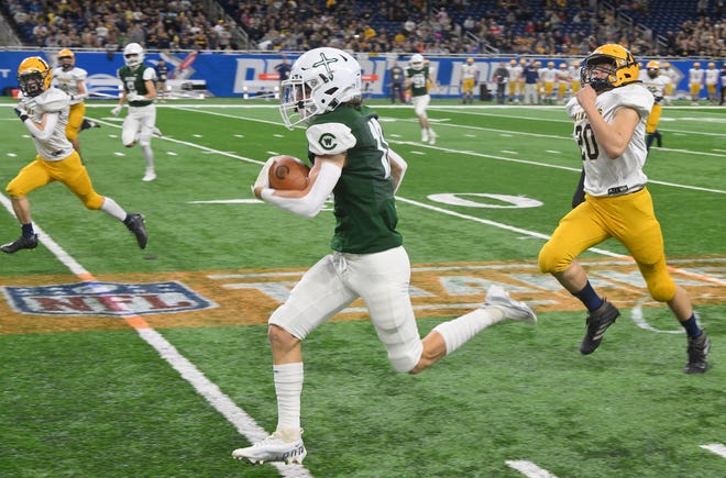 On the first offensive play of the game, West Catholic's Carter Perry runs down the field after a reception for a touchdown in the first half.