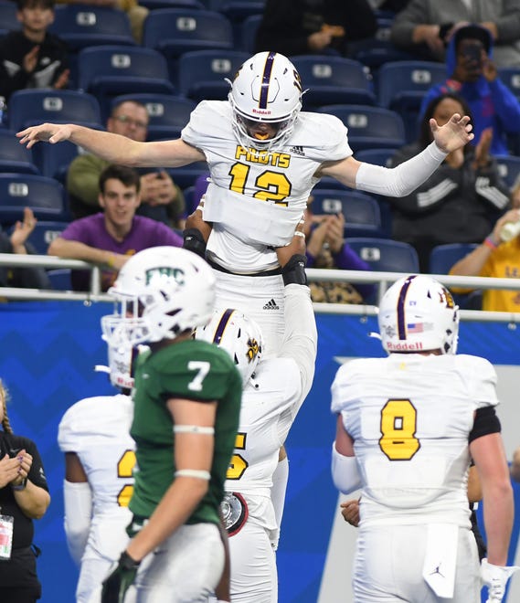 De La Salle quarterback Brady Drogosh is hoisted into the air celebrating his touchdown in the first half.