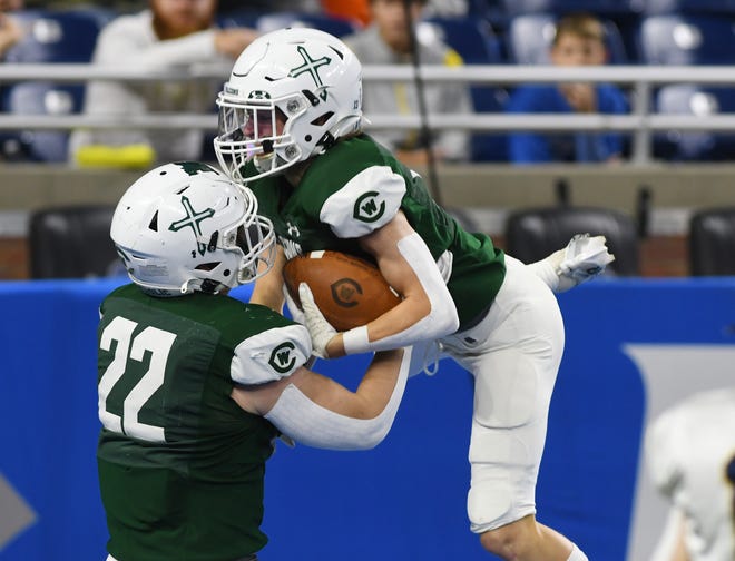 West Catholic's Timmy Kloska hoists Carter Perry into the air after his touchdown reception and run in the first half.