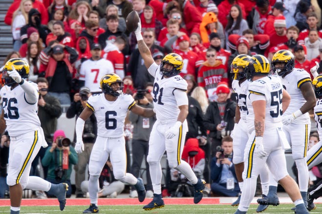 Michigan linebacker Taylor Upshaw (91) celebrates after intercepting a pass during the fourth quarter.