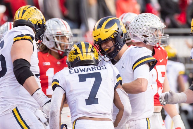 Michigan running back Donovan Edwards and quarterback J.J. McCarthy celebrate after Edwards scored a touchdown during the fourth quarter .