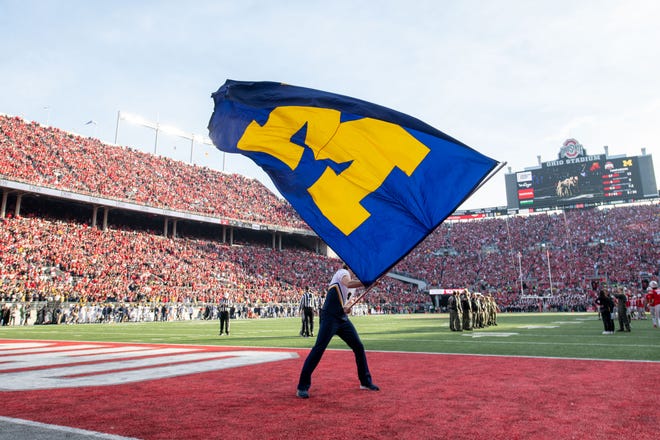 The Michigan flag is waved after a touchdown during the fourth quarter.