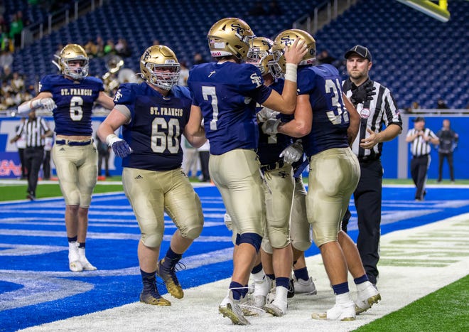 St. Francis players celebrate after a rushing touchdown by running back Joey Donahue (31) in the second quarter.