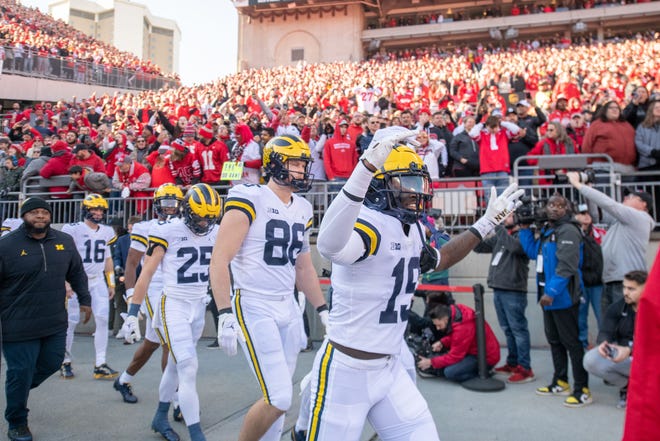 Michigan defensive back Rod Moore and the rest of the Wolverines come out onto the field for the start of a game at Ohio State.
