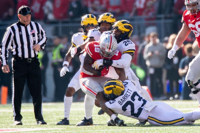 Ohio State's Chad Ray is tackled by several members of the Michigan defense during the first quarter.