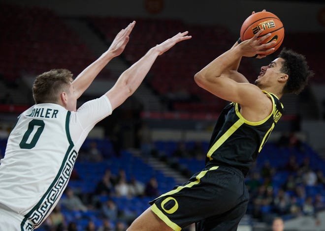 Oregon guard Will Richardson, right, shoots over Michigan State forward Jaxon Kohler during the first half of the Phil Knight Invitational tournament in Portland, Oregon, on Friday, Nov. 25, 2022.