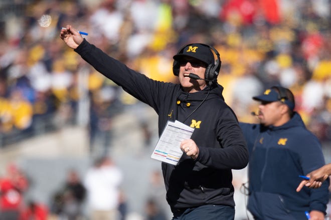 Michigan head coach Jim Harbaugh yells out to his players during the first quarter.