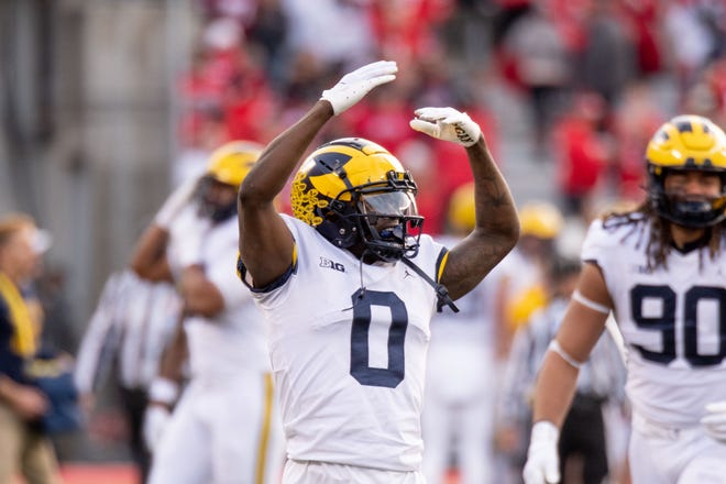 Michigan defensive back Mike Sainristil mimics the “O” sign of Ohio State during the final minutes of the 45-23 win.