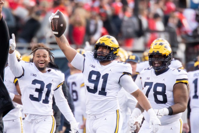 Michigan linebacker Taylor Upshaw (91) celebrates after intercepting a pass during the fourth quarter.
